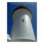 The dazzling white of a lighthouse against a deep blue sky. Byron Bay, Australia.